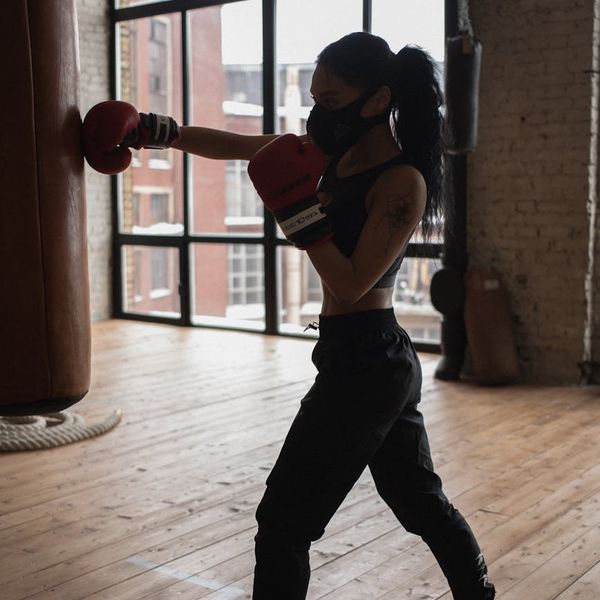Close-up of a person's focused face during a workout.